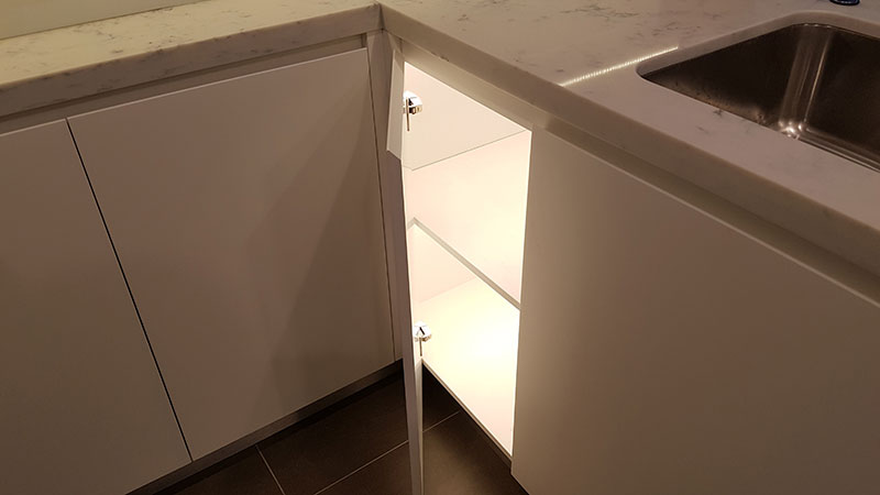 Corner kitchen cabinet with door activated LED lighting